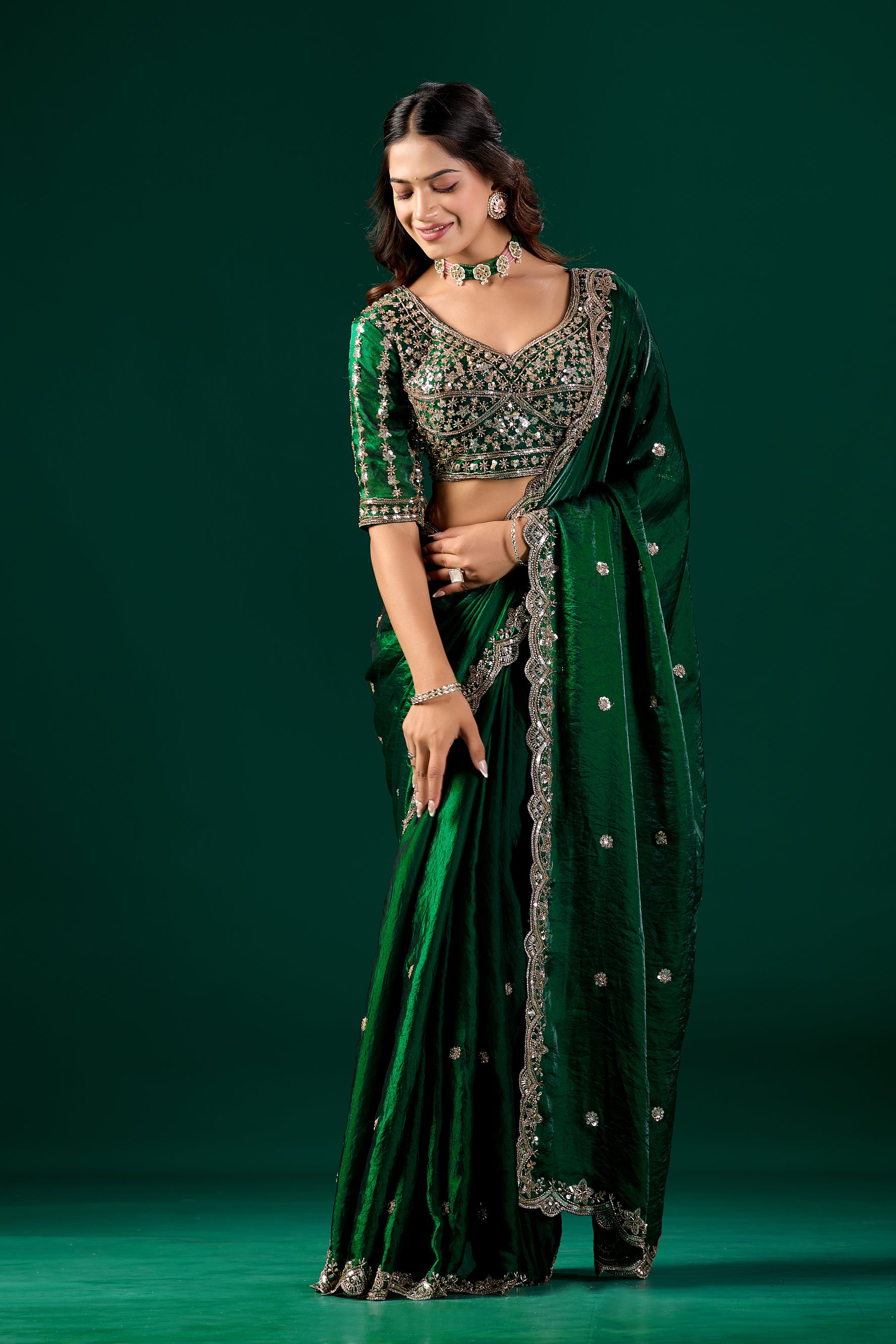 Full heavy green saree with intricate cutdana work by Kanyaari, showcasing detailed embroidery and traditional drape.