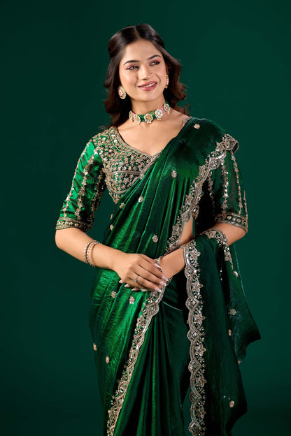 Heavy green saree with intricate cutdana work by Kanyaari, featuring detailed embroidery and traditional design.