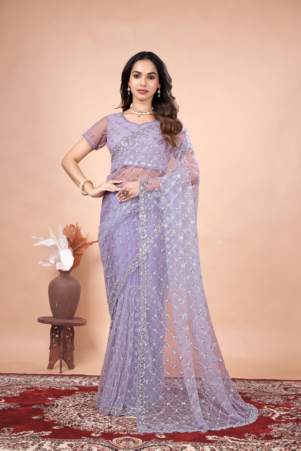 Green net saree with cutdana work by Kanyaari, featuring intricate embroidery and elegant drape.