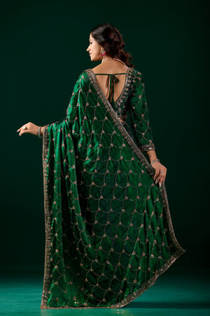 Green silk saree with rose gold cutdana work by Kanyaari, featuring intricate embroidery and elegant drape.