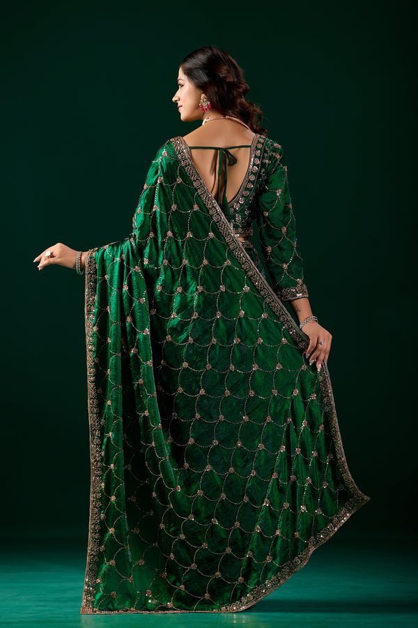 Green silk saree with rose gold cutdana work by Kanyaari, featuring intricate embroidery and elegant drape.