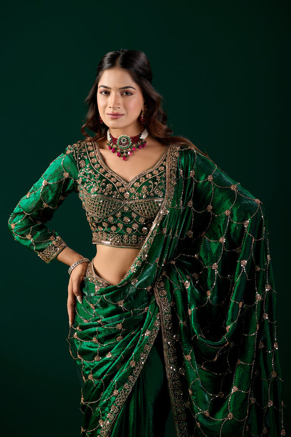 Green silk saree with rose gold cutdana work by Kanyaari, featuring intricate embroidery and elegant draping.