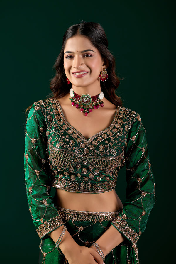 Green silk saree with rose gold cutdana embroidery by Kanyaari, featuring intricate detailing and elegant drape.
