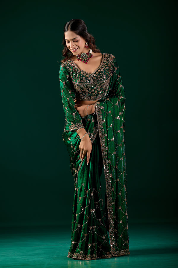 Green silk saree with rose gold cutdana work by Kanyaari, featuring intricate embroidery and elegant drape.