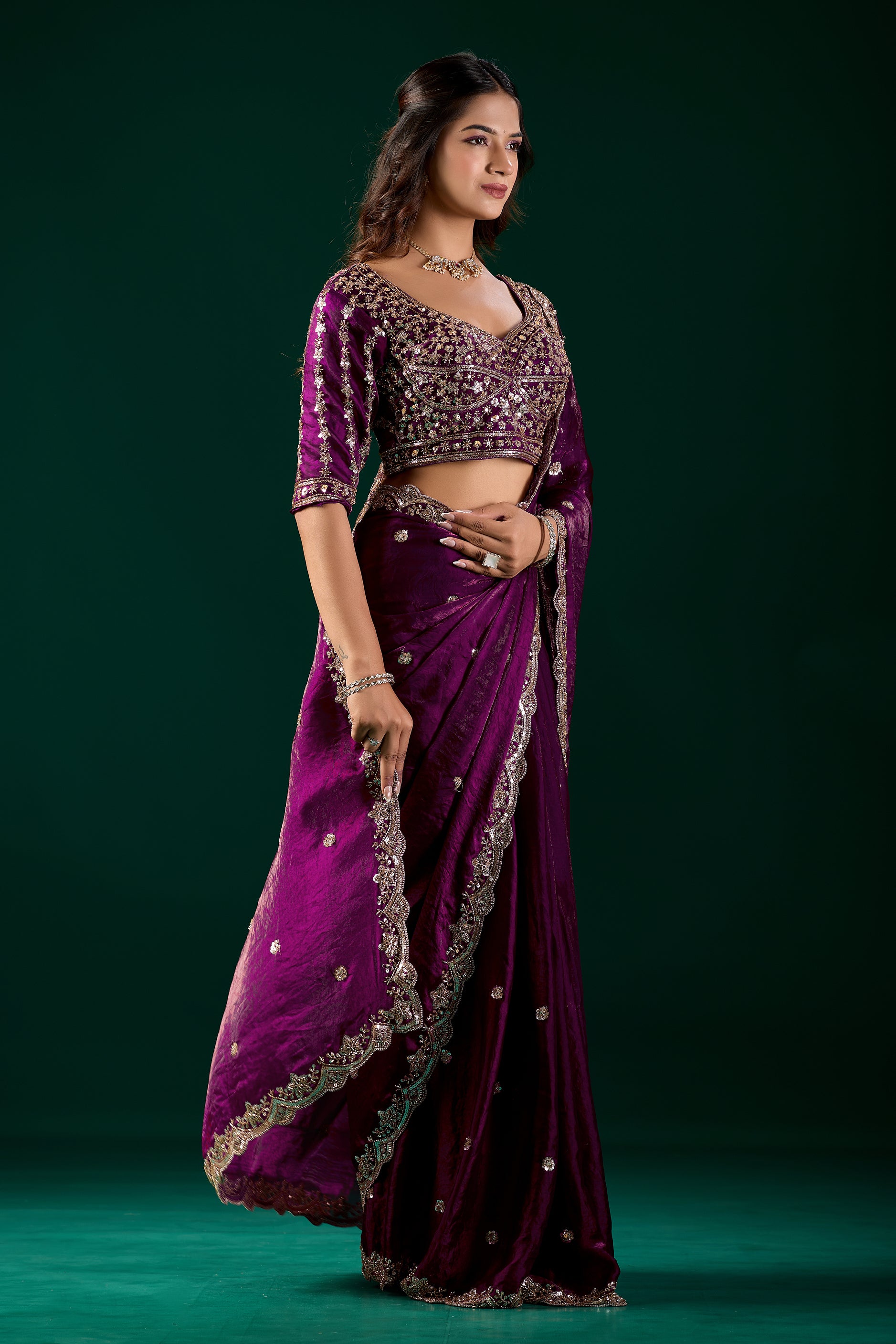 Elegant wine-colored saree with heavy cutdana embroidery by Kanyaari, showcasing intricate design and rich fabric.